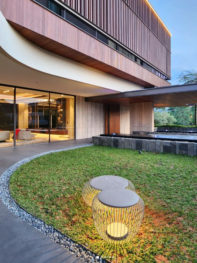 A tropical modern luxury villa featuring landscaped courtyards, reflective water bodies, contemporary architecture, bespoke interiors, and a seamless connection between nature and modern living.